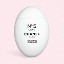 Chanel La Creme Main Hand cream 50ml oval shaped bottle in pink background