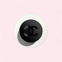 Birdeye view of N°1 DE CHANEL POWDER-TO-FOAM CLEANSER with a pink background