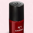 Red N°1 De Chanel Revitalizing Eye Serum 15ml bottle with black cap featuring Chanel logo on a light pink background