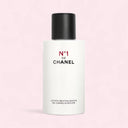 Chanel N°1 De Chanel Revitalizing Lotion 150ml bottle on a pink background