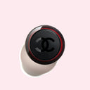 birdeye view of Chanel N°1 De Chanel Revitalizing Serum 30ml bottle against a pink background
