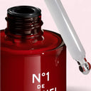 Chanel N°1 De Chanel Revitalizing Serum 30ml bottle with a dropper on a light pink background