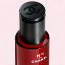 Chanel N°1 De Chanel Revitalizing Serum 30ml with black cap featuring Chanel logo on a light pink background