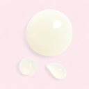 yellow drops of Chanel N°1 De Chanel Revitalizing Serum on a pink background