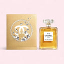 Chanel No. 5 perfume bottle and limited edition christnas packaging on a light pink background