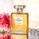Chanel No. 5 eau de parfum perfume bottle with flowers and diamonds in the background