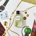 Chanel Paris Edimbourg EDT 125ml  perfume bottles on a decorative surface with jewelry and a watch.