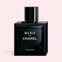 BEAUTE KNOWS Darkest navy blue Chanel Bleu de Chanel L'Exclusif 100ml perfume bottle with 'Bleu de Chanel L'Exclusif' text on a light pink background