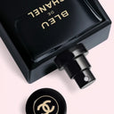 BEAUTE KNOWS Bleu de Chanel L'Exclusif perfume bottle with gold text on a light pink background