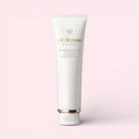 White Clé de Peau Beauté Clarifying Cleansing Foam 125ml tube with gold accents on a light pink background