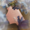 BEAUTE KNOWS Pink Creed Spring Flower Eau De Parfum 75ml perfume bottle with flowers in the background