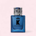 Blue Dolce & Gabbana K Eau de Parfum 50ml perfume bottle with decorative cap on a light pink background