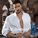 Man in a white shirt withDolce & Gabbana K Eau de Parfum perfume bottle