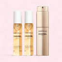 Gabrielle Chanel Eau de Parfum perfume twist and spray bottle with 2 20ml refillable vial on a pink background