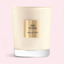 Candle with 'Thé Yulong Armani Prive' label on a pink gradient background
