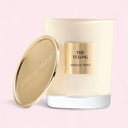 Armani Prive Thé Yulong candle with gold lid on a pink background