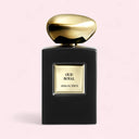 Black and gold Armani Prive Oud Royal perfume bottle on a light pink background