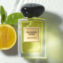 Perfume bottle labeled 'Orangerie Venise' by Armani/Prive with a sliced orange and leaves on a light background