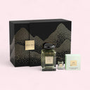 Perfume set with bottles and packaging on a light pink background