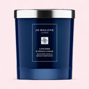 dark blue Jo Malone lavender and moonflower scented candle with silver lid on a pink background