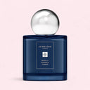Jo Malone Midnight Camomile cologne bottle on a light pink background
