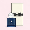 Jo Malone cologne bottle with a black bow on a light pink background