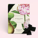 Jo Malone London English Pear & Freesia cologne 30ml duo set packaging with flowers and a bow on a light pink background