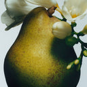 BEAUTE KNOWS Jo Malone London Pear with white freesia flowers on a light gray background