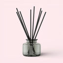 BEAUTE KNOWS Jo Malone London Jade Glass Diffuser bottle with black sticks on a pink background