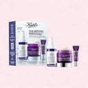 Kiehl's Age-Defying Essentials Set on a light pink background