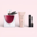 Lancôme La Vie Est Belle L'Elixir L'eau De Parfum perfume, lotion, and mascara on a pink background