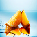 BEAUTE KNOWS Two orange wedges on a reflective water surface with a blue gradient background
