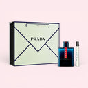 Prada Luna Rossa Ocean Eau De Toilette 100ml Gift Set with a 100ml bottle, a travel spray and packaging on a light pink background