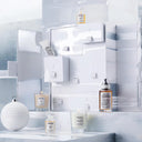 Maison Margiela Replica Advent Calendar with various products including perfume bottles, skincare and candles on a white background.