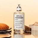 Maison Margiela Replica Afternoon Delight Eau de Toilette 100ml perfume bottle with soft light yellow background