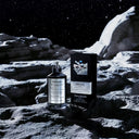 Maison Margiela Replica Fantasies Dancing On The Moon Eau de Parfum 100ml Perfume bottle and packaging on a moon-like surface with starry sky