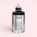 black and silver Maison Margiela Replica Fantasies Ideal One Eau De Parfum 100ml perfume bottle on a light pink background