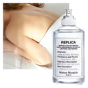 Maison Margiela Replica Lazy Sun Morning Eau de Toilette 100ml perfume bottle with a blurred background of a woman's back.