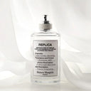 Maison Margiela Replica Lazy Sun Morning Eau de Toilette 100ml perfume bottle with white sheer curtain background