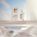Maison Margiela Replica Lazy Sun Morning Eau de Toilette 100ml perfume bottle and packaging on white handrail 