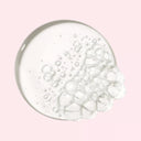 BEAUTE KNOWS Maison Margiela Replica Lazy Sunday Morning Shower Gel Clear gel with bubbles on a pink background
