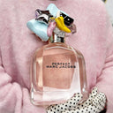 Marc Jacobs Perfect perfume bottle with colorful cap on a pink background