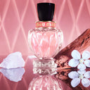 Miu Miu Twist Eau de Parfum 100ml perfume bottle with decorative elements on a pink background