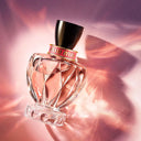 Miu Miu Twist Eau de Parfum 100ml perfume bottle with a gold cap on a pink and purple gradient background
