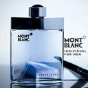 Montblanc Individuel Eau de Toilette 75ml perfume bottle on a reflective surface with a pen.