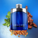 Montblanc Legend Blue Eau de Parfum 100ml perfume bottle with leaves and wood on a blue background