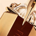 Close-up of Mugler Alien Goddess Intense Eau de Parfum 30ml perfume nozzle and bottle with a beige background