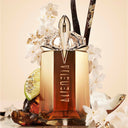 Mugler Alien Goddess Intense Eau de Parfum 30ml perfume bottle with flowers and vanilla bean on a beige background