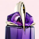 close up of Mugler Alien Refillable Eau de Parfum 60ml spray nozzle with gold accents on a reflective surface