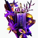 Purple Mugler Alien Refillable Eau de Parfum 60ml perfume bottle with gold cap surrounded by flowers on a white background